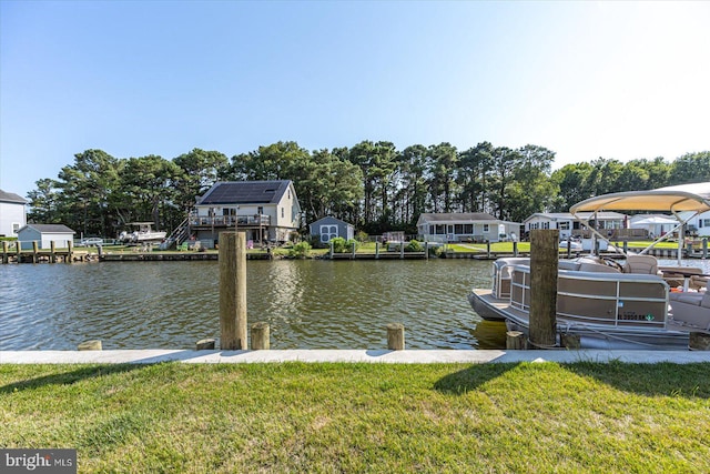 view of dock featuring a yard and a water view