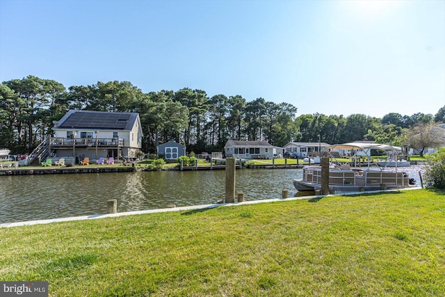 dock area featuring a yard and a water view