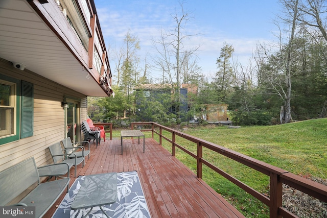 wooden terrace with a lawn