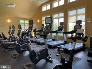 gym featuring vaulted ceiling