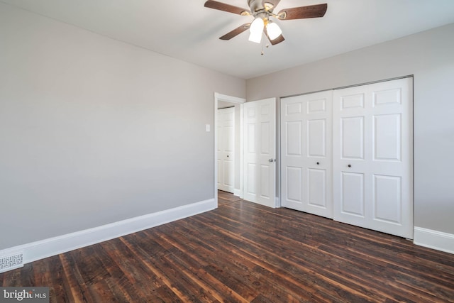 unfurnished bedroom featuring a closet, ceiling fan, and dark hardwood / wood-style flooring