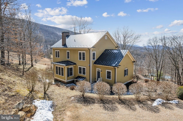 rear view of property featuring a mountain view