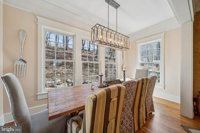 dining room featuring ornamental molding, a chandelier, and wood-type flooring