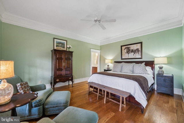 bedroom with hardwood / wood-style flooring, ceiling fan, crown molding, and connected bathroom