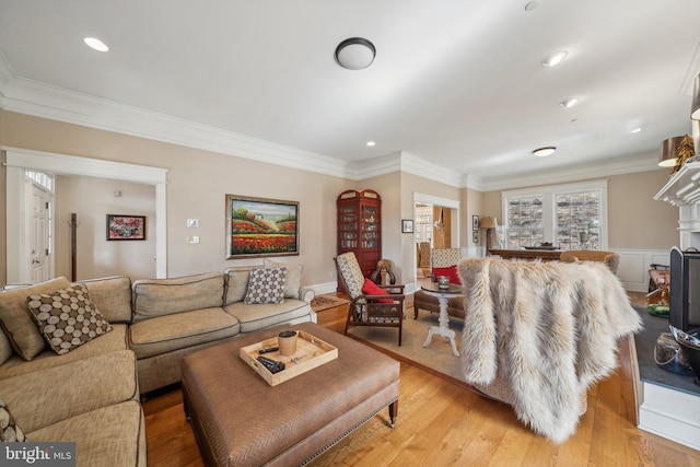 living room featuring light wood-type flooring and ornamental molding