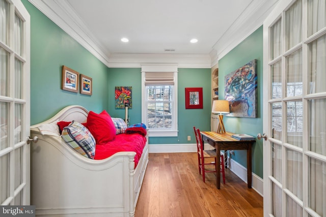 living area with ornamental molding, french doors, and hardwood / wood-style floors