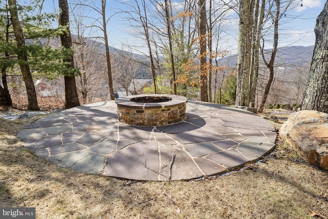 view of patio / terrace featuring a fire pit and a mountain view