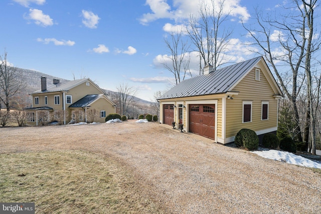 view of home's exterior featuring a garage and a mountain view