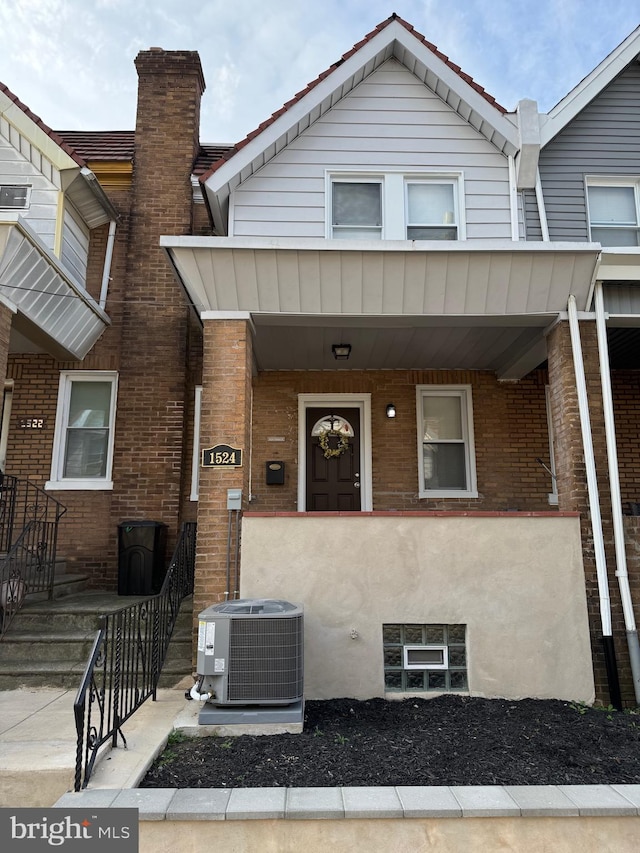 view of property featuring cooling unit and a porch