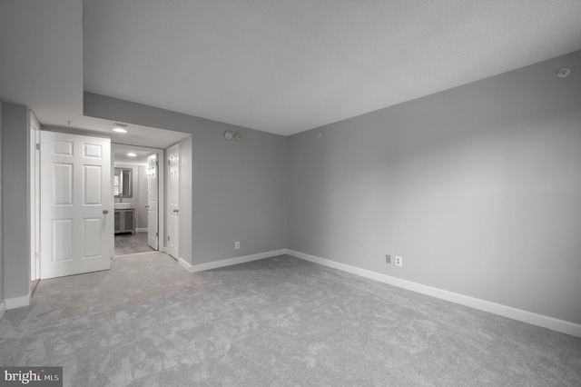 carpeted spare room with baseboards