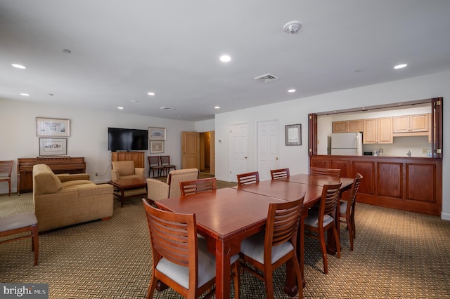 view of carpeted dining area