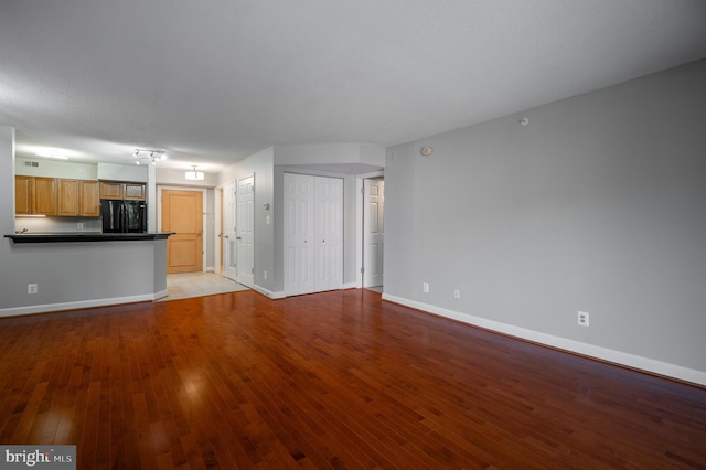 unfurnished living room with light wood-type flooring