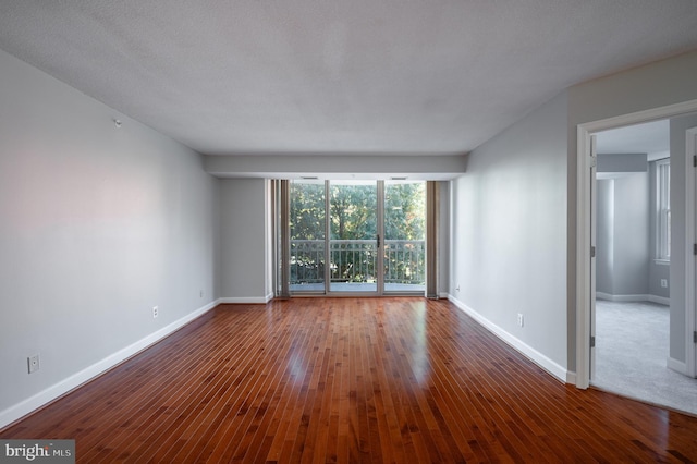 spare room with hardwood / wood-style flooring and a textured ceiling