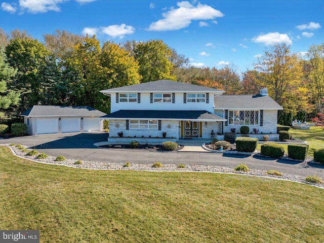 view of front of home with a front yard and a garage