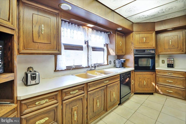 333 W Arch St, Frackville, PA 17931 - kitchen with brown cabinetry, light tile patterned floors, light countertops, black appliances, and a sink