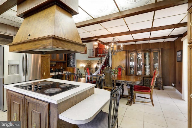 333 W Arch St, Frackville, PA 17931 - kitchen with light tile patterned floors, light countertops, black electric cooktop, island exhaust hood, and a notable chandelier