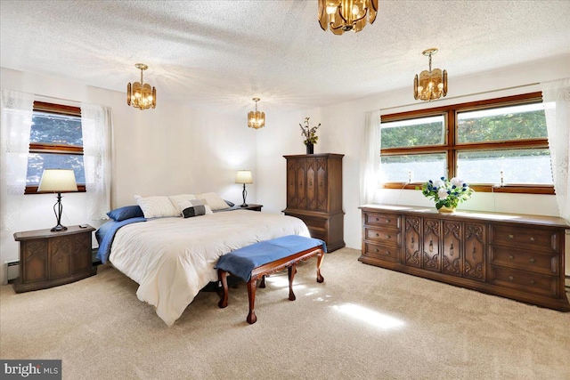 carpeted bedroom with a baseboard heating unit and a textured ceiling