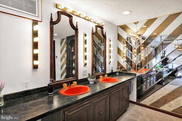 bathroom with vanity and a textured ceiling