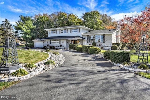 333 W Arch St, Frackville, PA 17931 - view of front facade featuring driveway, a chimney, a front lawn, and stone siding