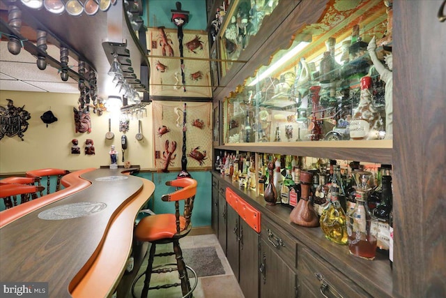 bar with dark brown cabinetry