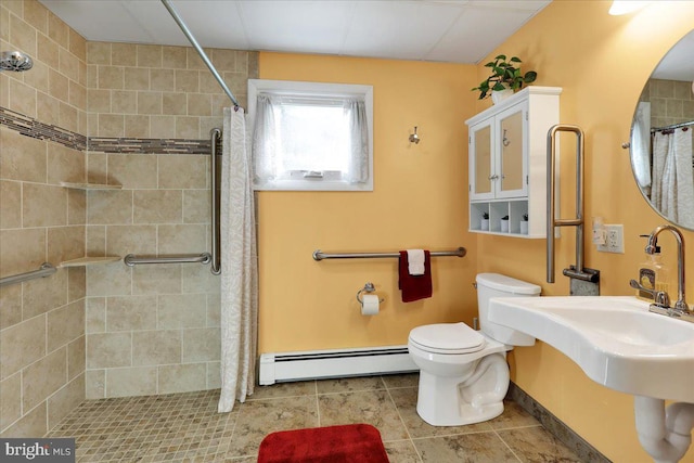 333 W Arch St, Frackville, PA 17931 - bathroom with tile patterned floors, a tile shower, toilet, and a baseboard heating unit