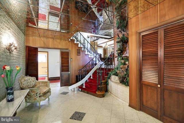 333 W Arch St, Frackville, PA 17931 - stairs with tile patterned floors, wooden walls, a baseboard heating unit, and a high ceiling