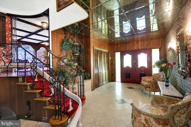 333 W Arch St, Frackville, PA 17931 - entrance foyer featuring stairway, french doors, brick wall, and a high ceiling