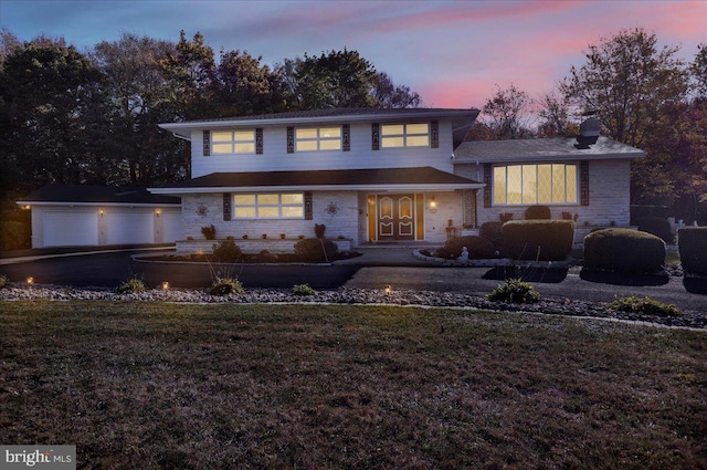 view of front facade with a yard and a patio