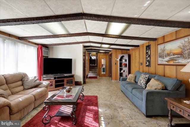 living room with wood walls and a wall mounted AC