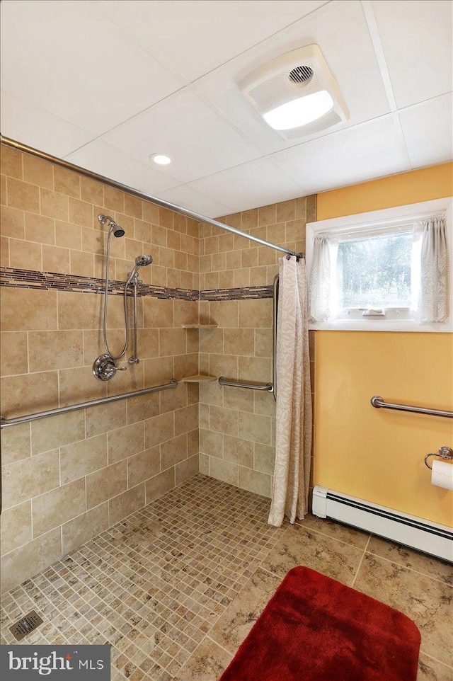 bathroom with baseboard heating and a shower with shower curtain