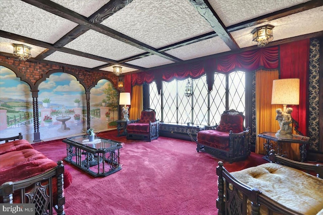 living room with a textured ceiling, beamed ceiling, coffered ceiling, and carpet