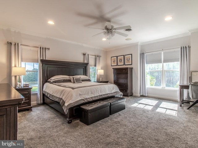 carpeted bedroom featuring multiple windows, ceiling fan, and crown molding