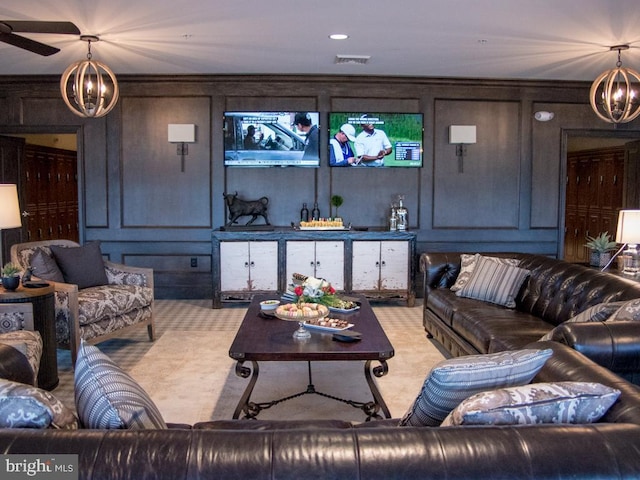 living room with carpet floors, wooden walls, and ceiling fan