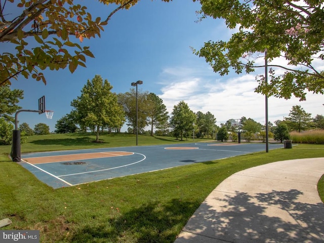 view of basketball court featuring a lawn