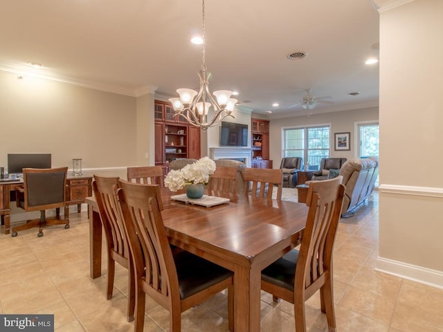 tiled dining space featuring ornamental molding and ceiling fan with notable chandelier