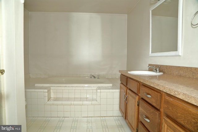 bathroom with vanity and tiled tub