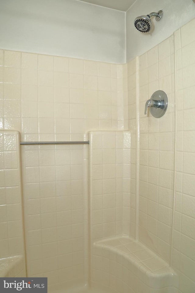 bathroom with a tile shower