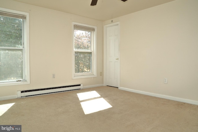 carpeted spare room featuring ceiling fan and a baseboard radiator