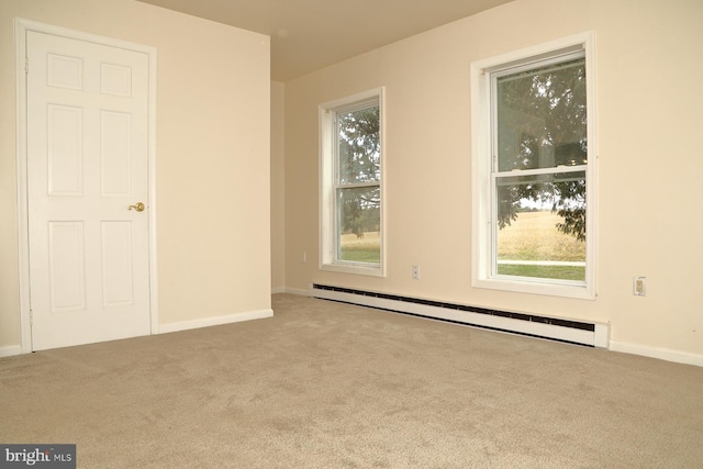 carpeted empty room with baseboard heating