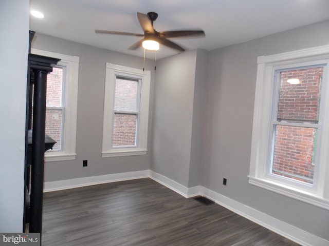 empty room featuring ceiling fan and dark hardwood / wood-style flooring