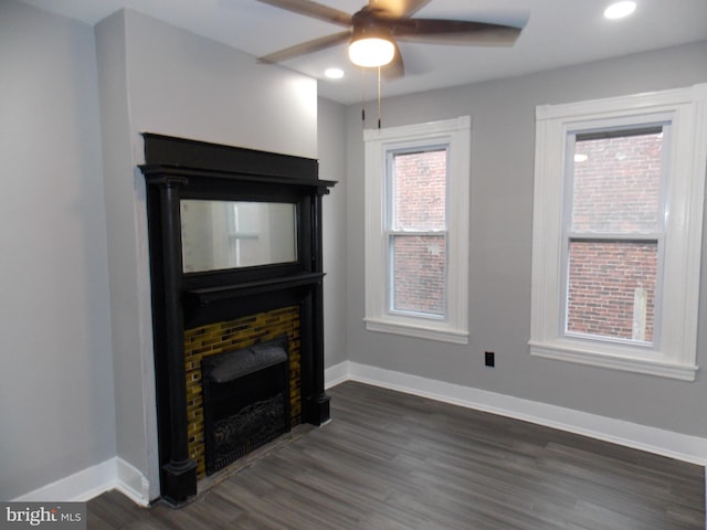 living room featuring ceiling fan and dark hardwood / wood-style floors