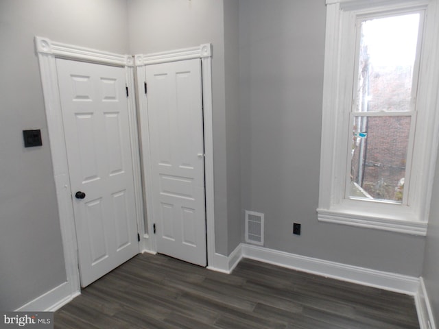 interior space with dark hardwood / wood-style flooring