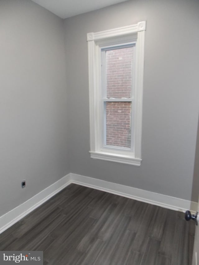 empty room with dark hardwood / wood-style floors