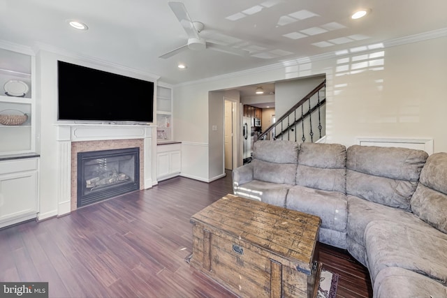 living room featuring ornamental molding, dark hardwood / wood-style flooring, and built in shelves