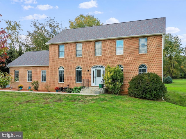 colonial-style house with a front lawn