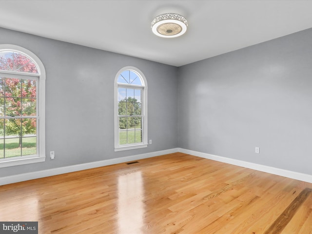 empty room with light hardwood / wood-style floors