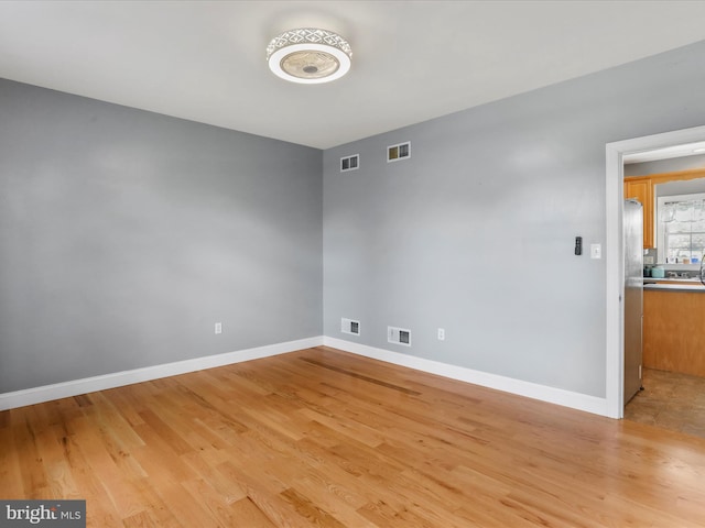 spare room with light wood-type flooring