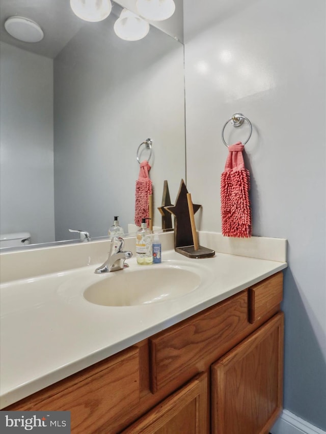 bathroom featuring toilet and vanity