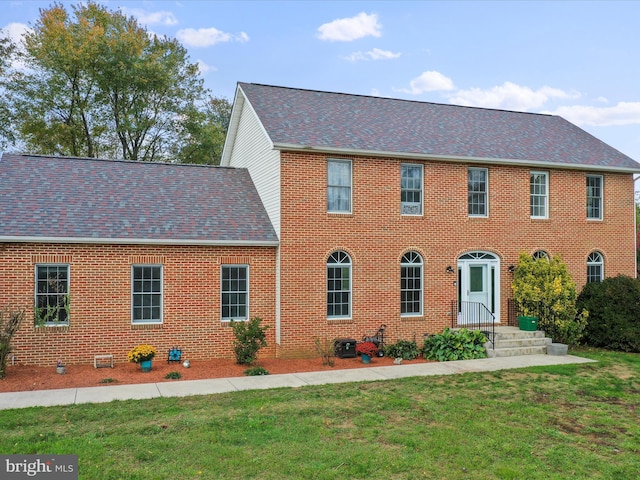 colonial home with a front lawn