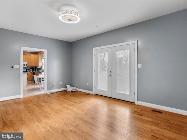 interior space featuring light hardwood / wood-style flooring and french doors